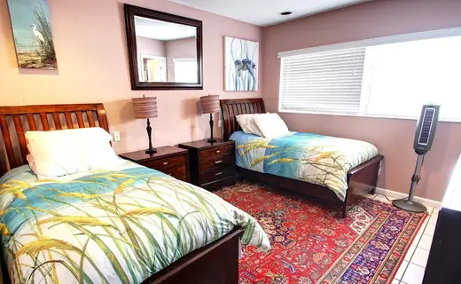 Cozy bedroom with two beds at Summer House Detox, a detox center in Miami.