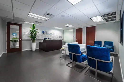 Modern reception area with blue chairs at Legacy Healing Center, a detox center in Miami.