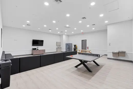 Spacious common area with seating and entertainment at Renaissance Recovery - Palm Beach, a detox center in Miami.