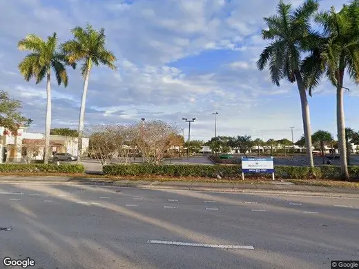 Palm trees outside Fellowship Recovery Community Organization, a sober living home in Miami.