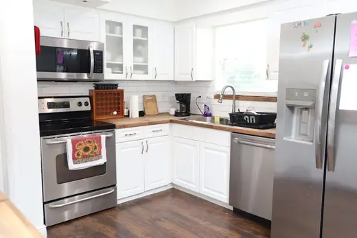 Modern kitchen with stainless steel appliances at House of Discernment, a treatment center in Miami.