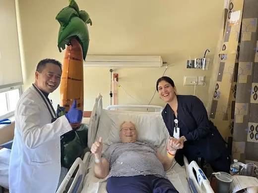 Smiling patient with caregivers at Broward Health North Rehabilitation Institute treatment center in Miami.